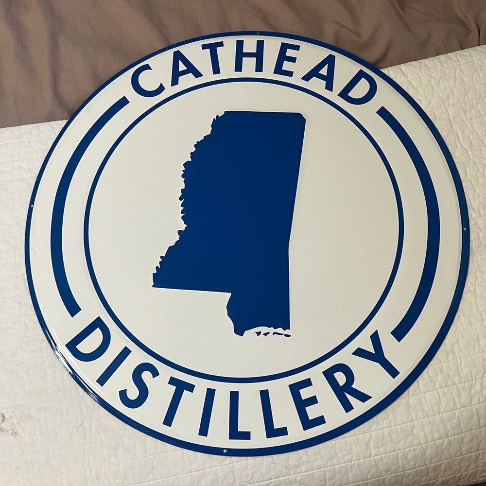 Cathead Mississippi vodka distillery tin sign